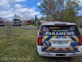 M105 staged in the front yard of the working fire.