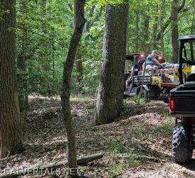 Captain 10 on the back of UTV3 with the patient.