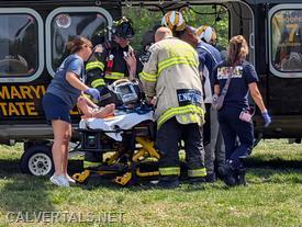 Crews transitioning patient into the aircraft for transport.